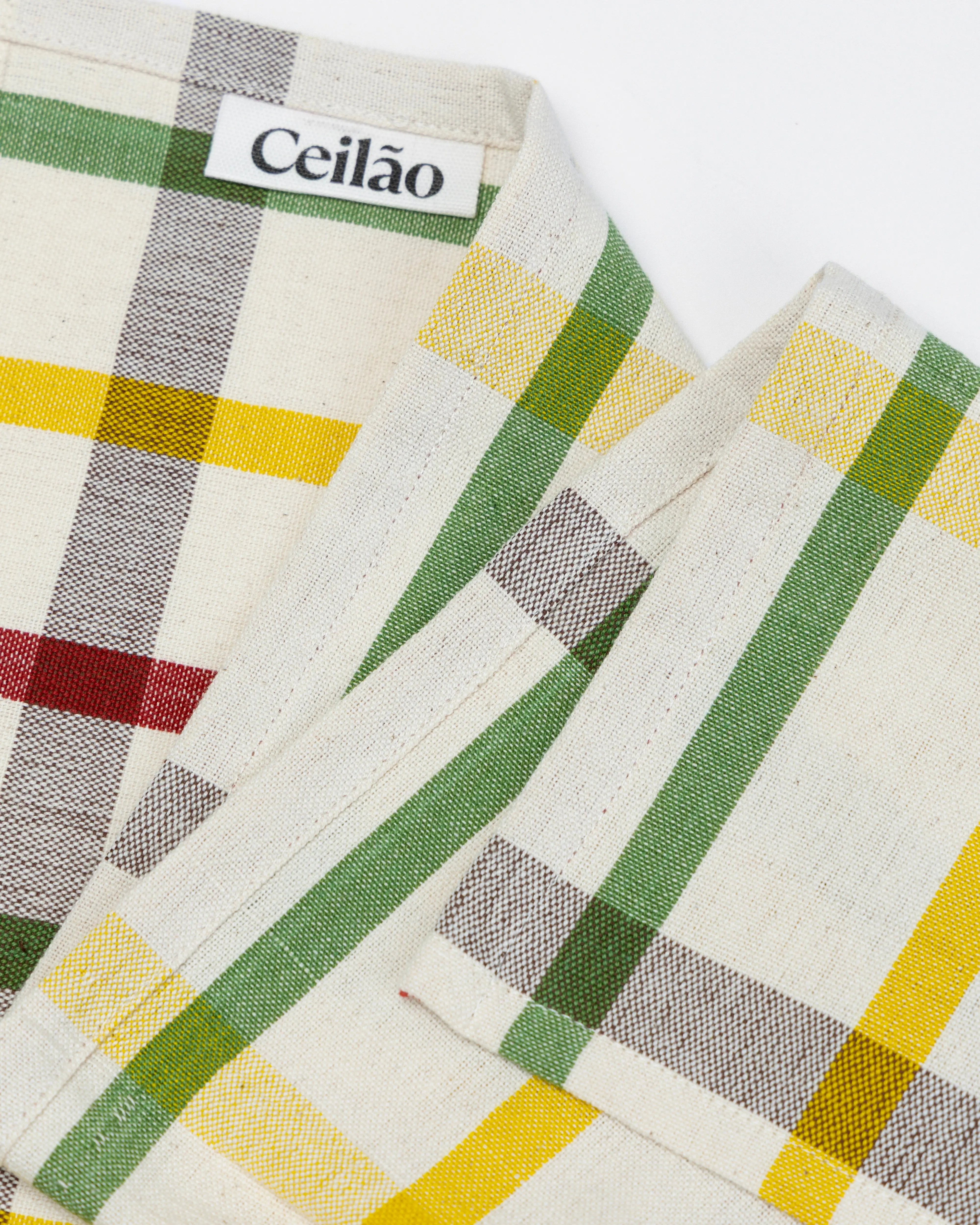 Close-up of hand made tea towel with 'Ceiláo' branding on a white background