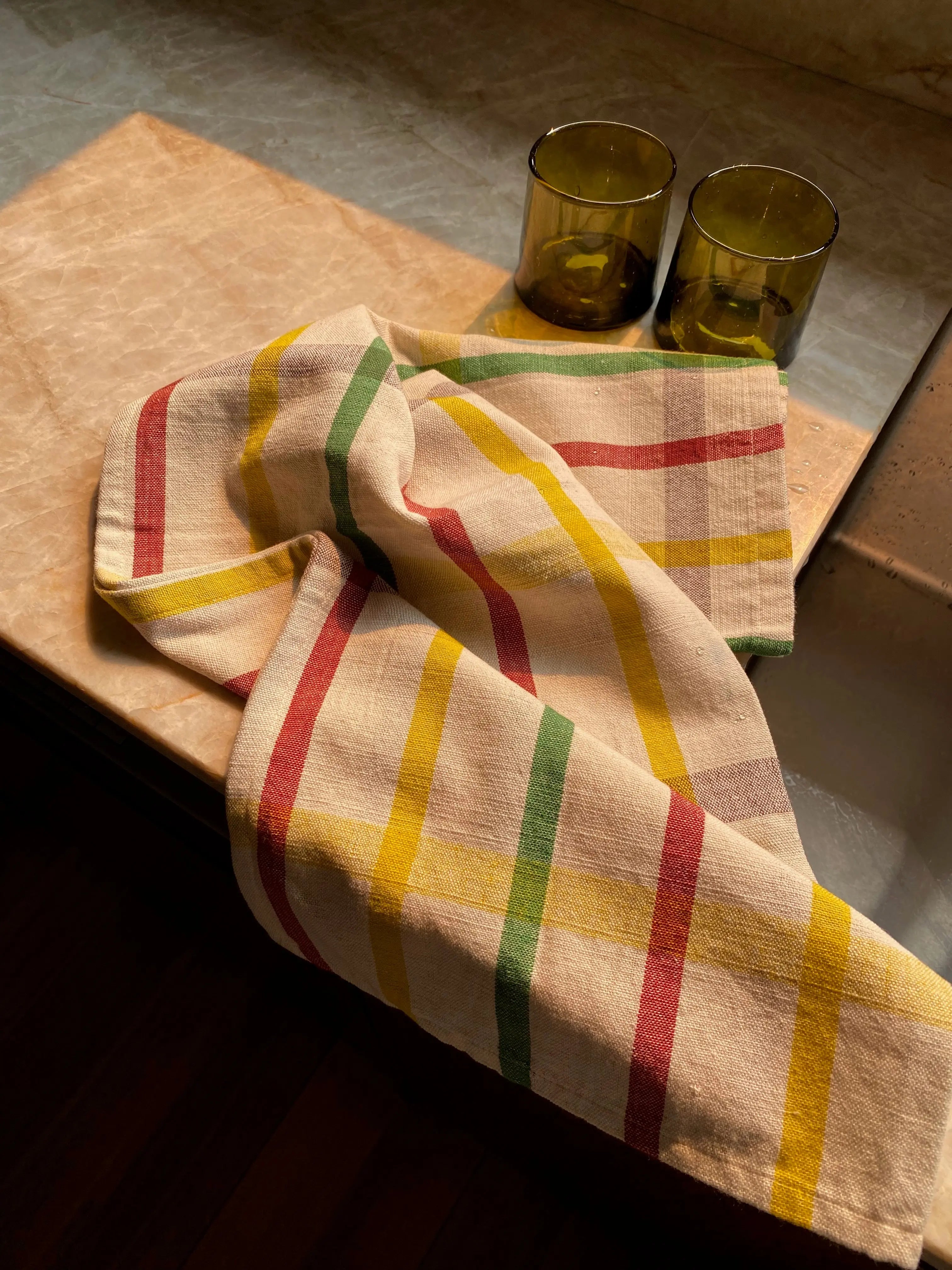 Hand woven cotton Galle checked tea towel draped over kitchen bench